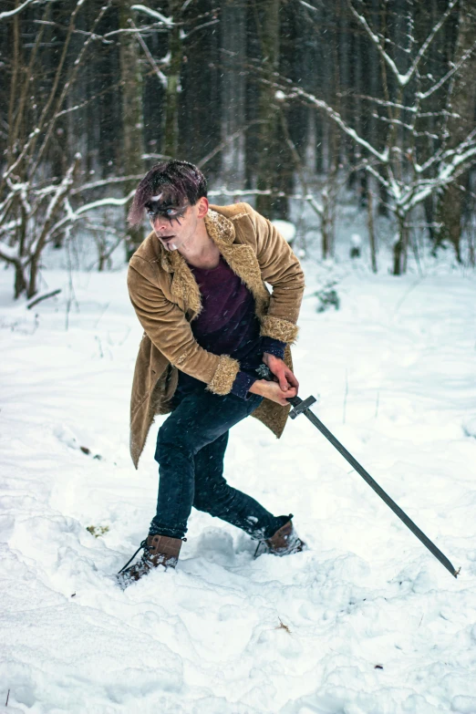 the young man is playing with his skiis in the snow