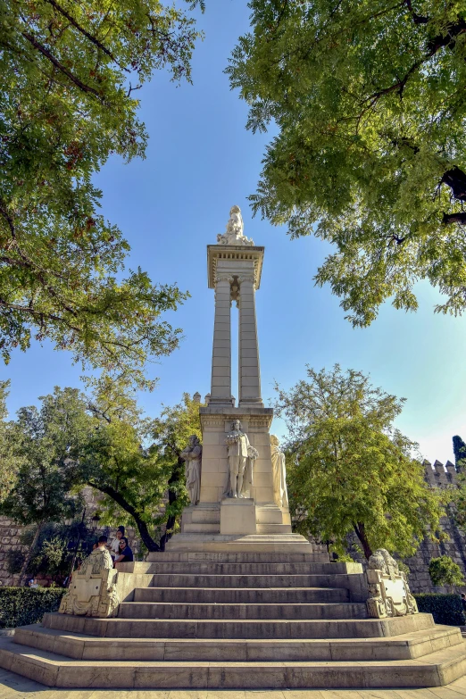 a steeple has stairs on either side and a statue on top