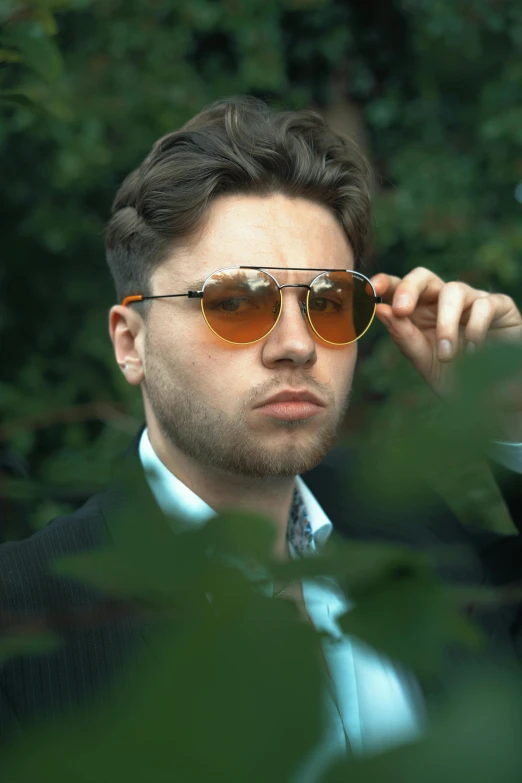 man in suit and sunglasses staring to the right