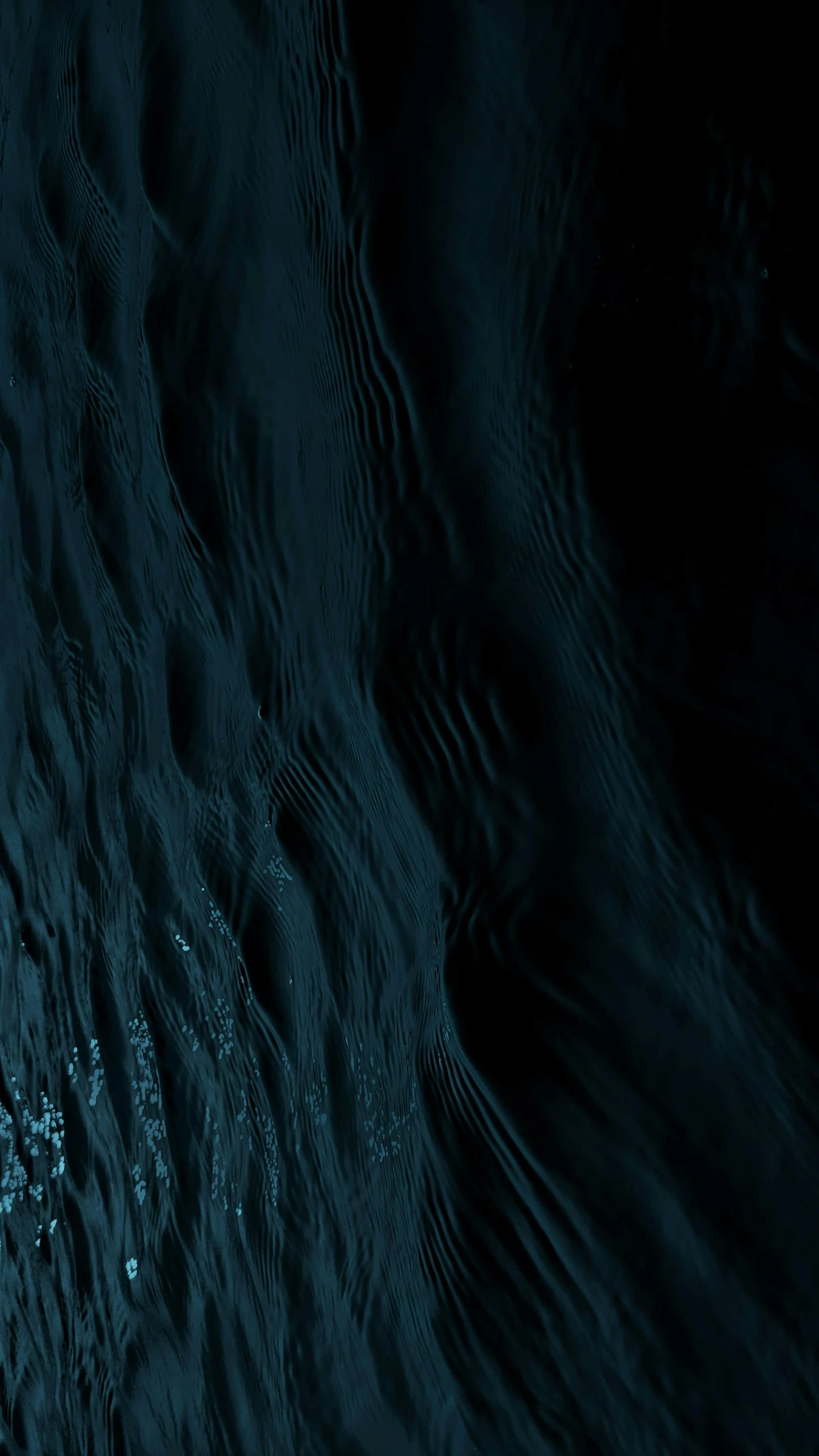 a dark water surface with ripples and lines in it