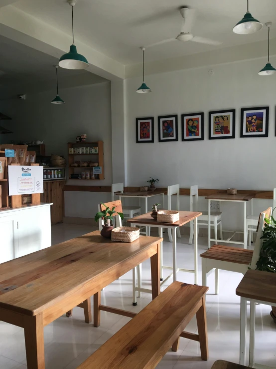 several different sized wooden benches sitting in front of tables