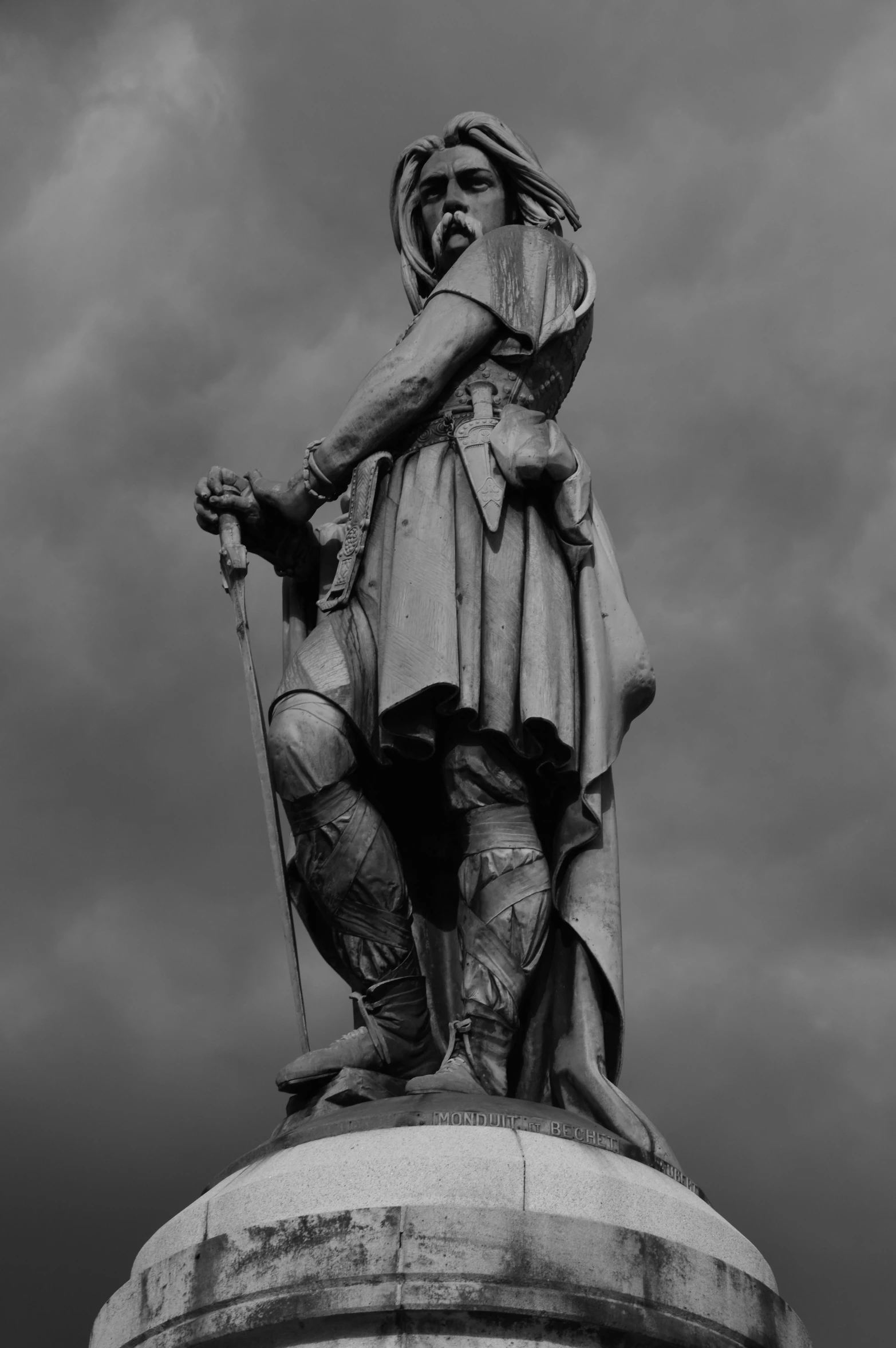 an elaborate statue atop a big white column