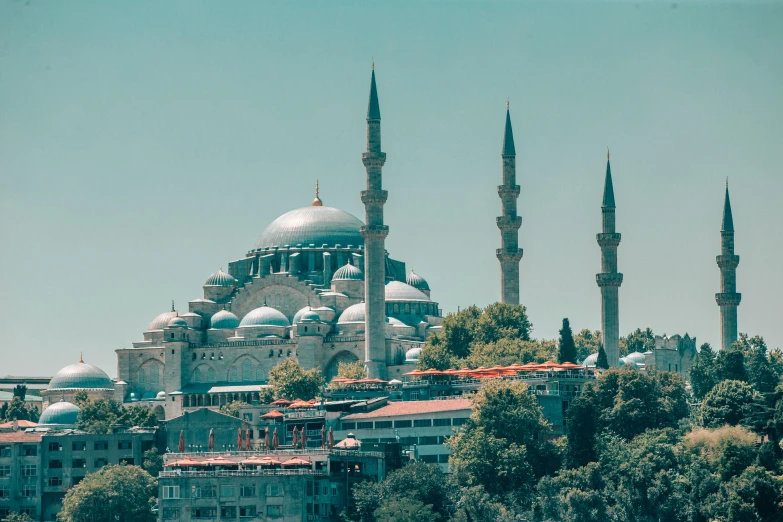 a building with multiple towers and domes is situated in a wooded area