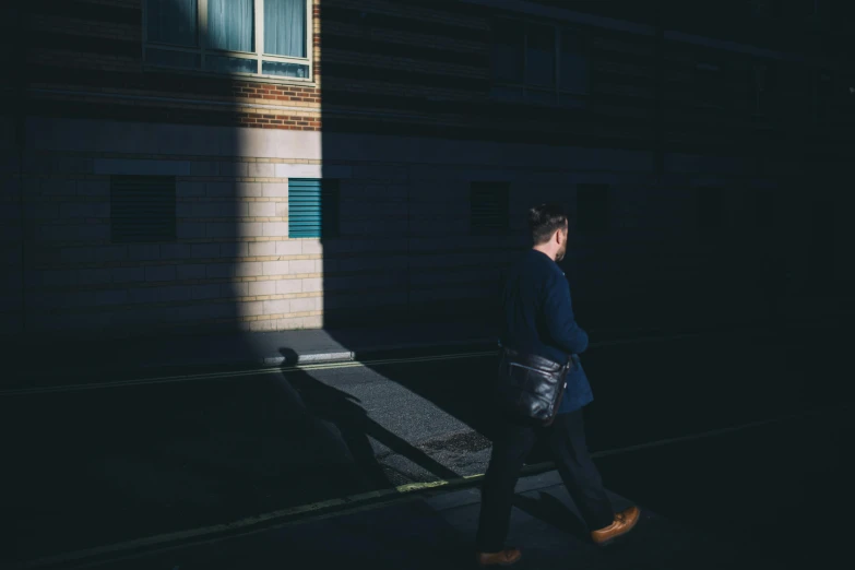 a man walking in the dark on a street