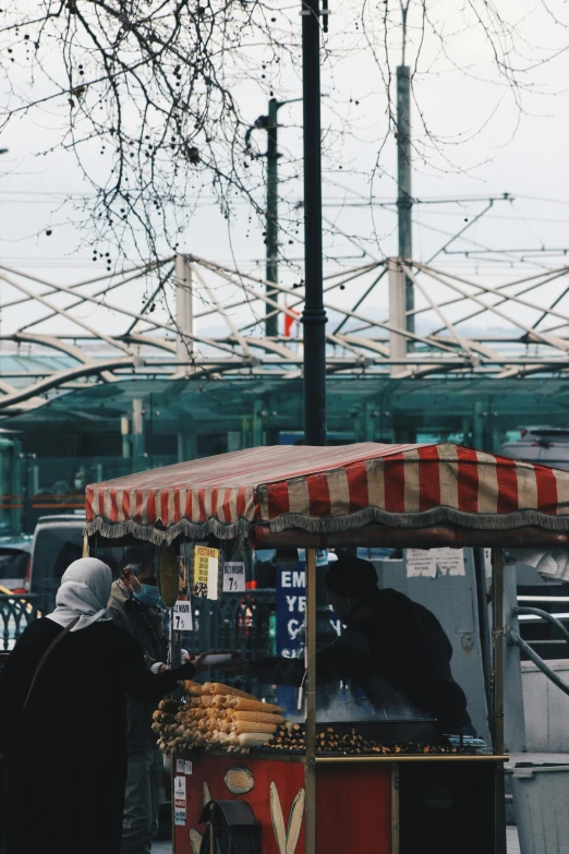 an vendor with two bears is selling some food