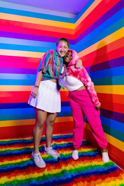 two female dancers on a multi colored striped stage