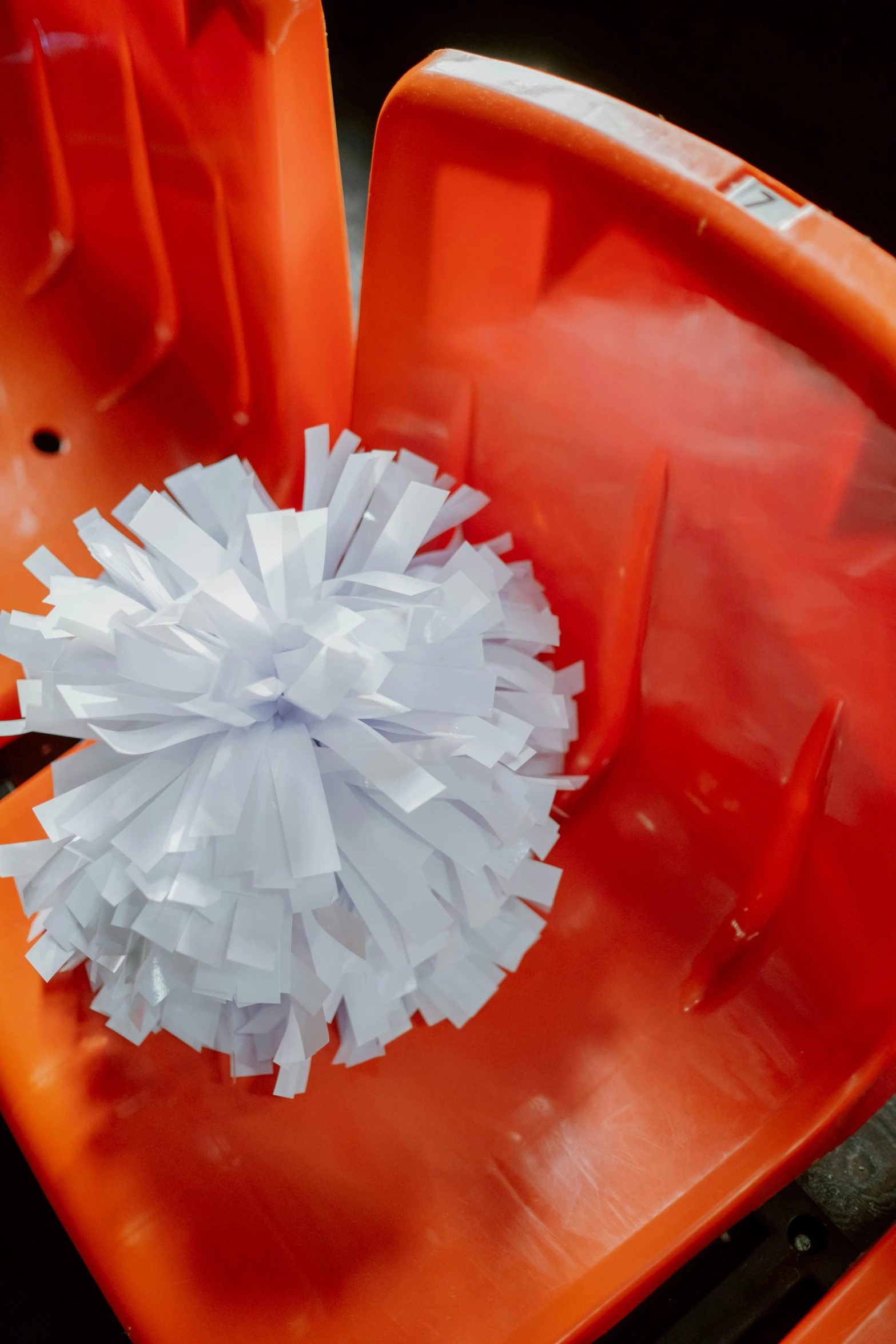 a plastic chair with paper balls on it