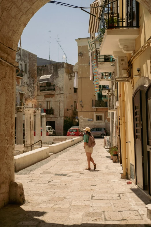 the girl is walking down the street in the city