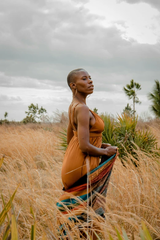 a woman in an african landscape poses for a po