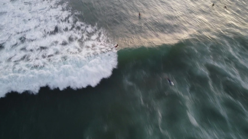 a view from above of a person surfing on the waves