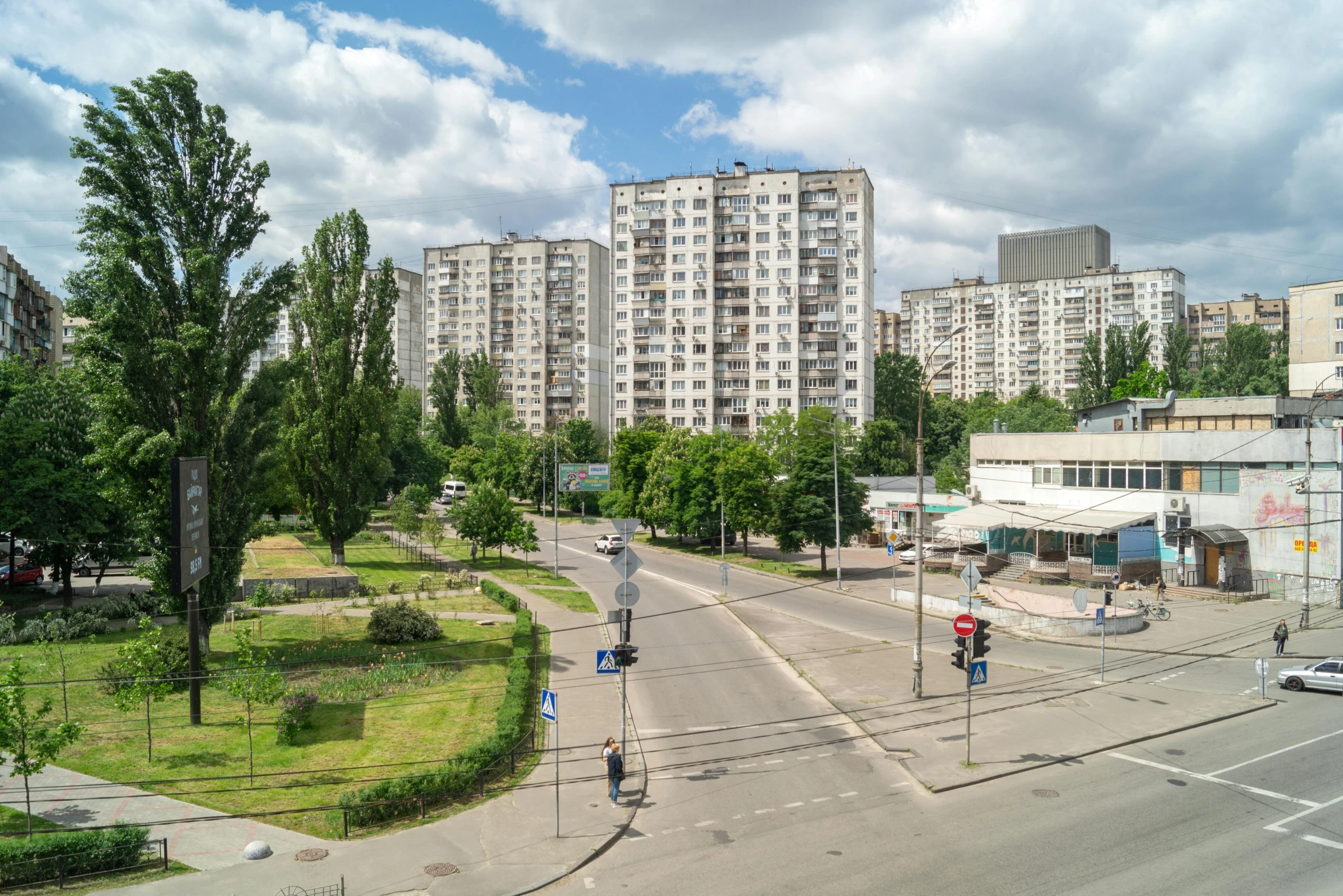 the view of an open street that has buildings on both sides