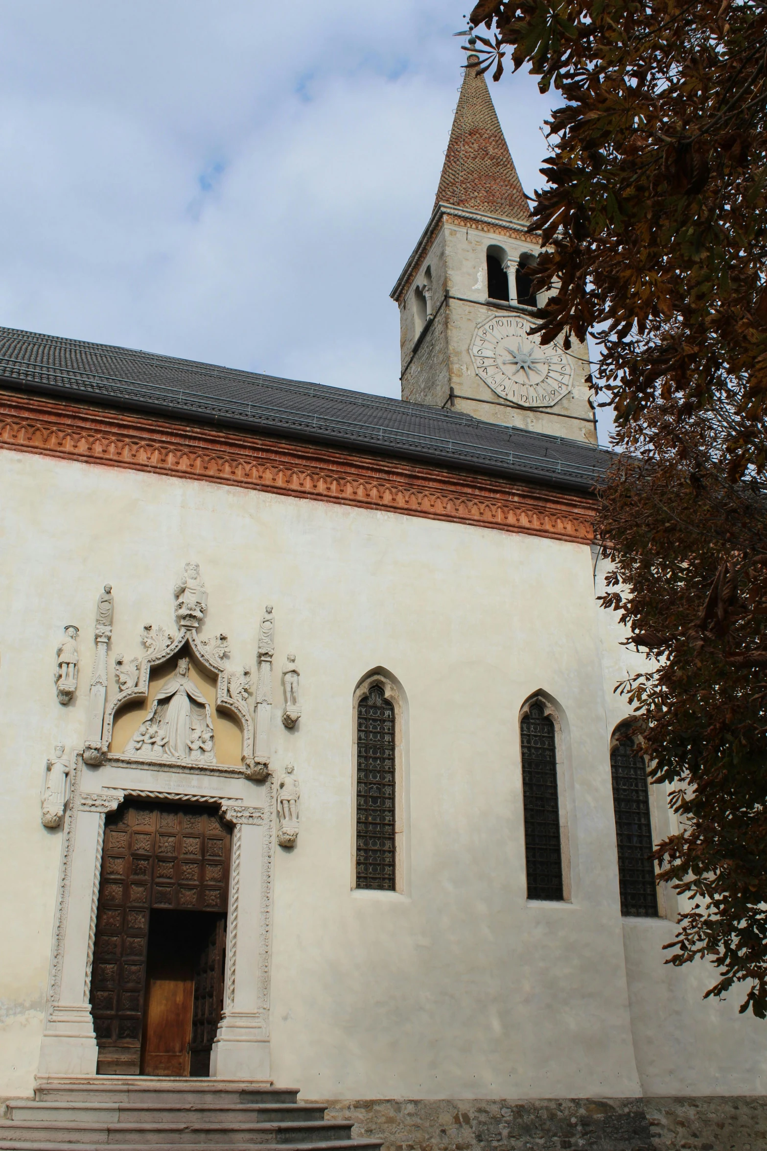 a building with an archway, window and a clock tower