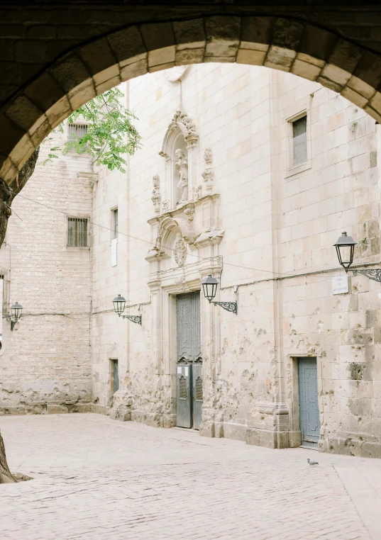 an arch over a street has an open doorway