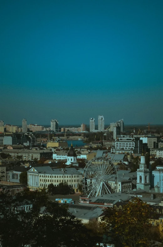 a large ferris wheel sitting on top of a tall building