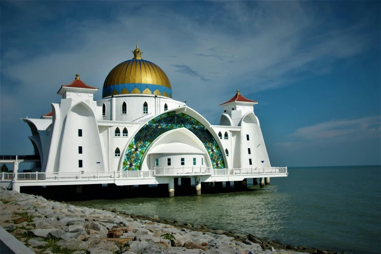 a large building by the water with some domes