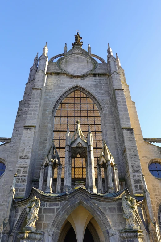 an intricate cathedral with statues on its facade