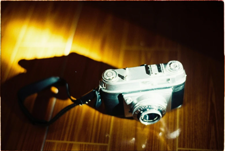 an old po camera sitting on a wooden table