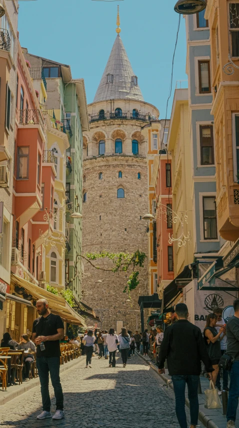 people walking around in the street of a narrow city