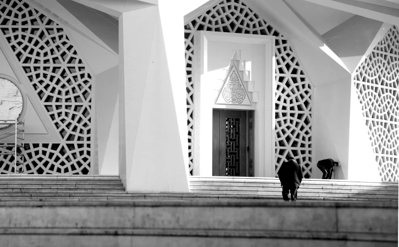 two people are walking down stairs towards a building