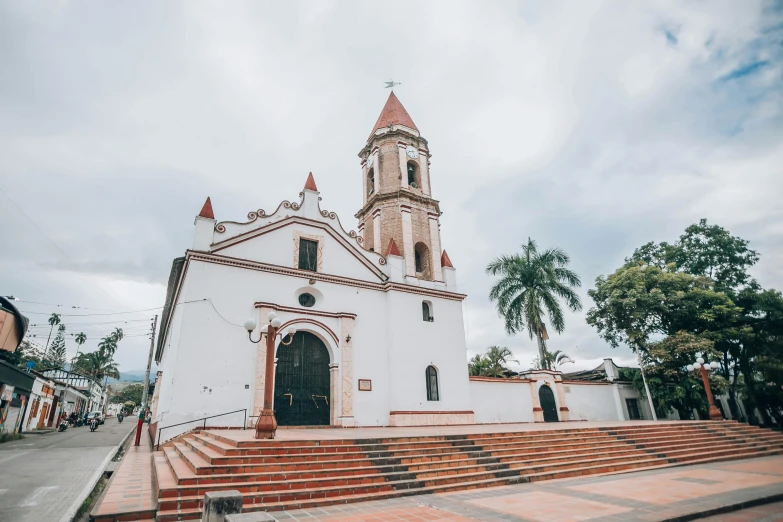 a church on a hill with red steps leading up