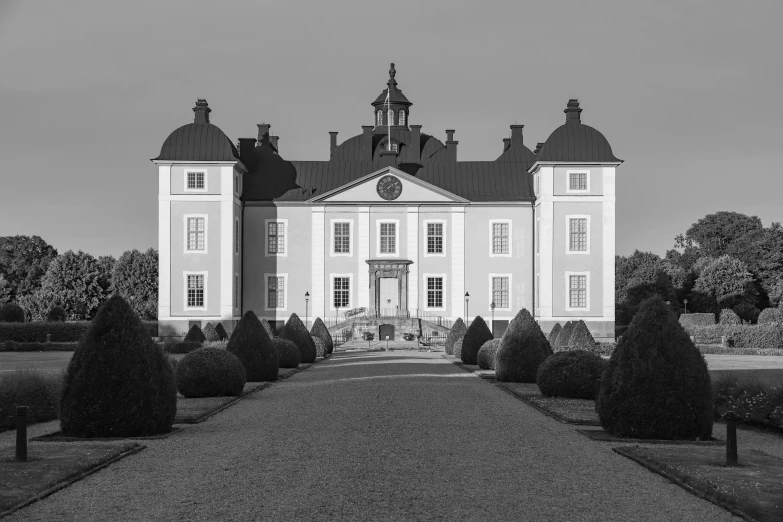 black and white pograph of a building with a clock on the top