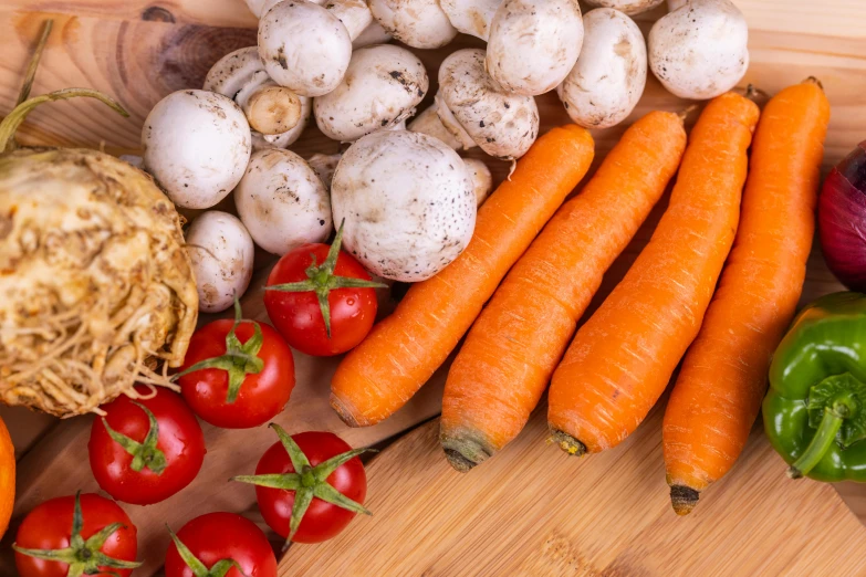 carrots, onions and green peppers sit on the table