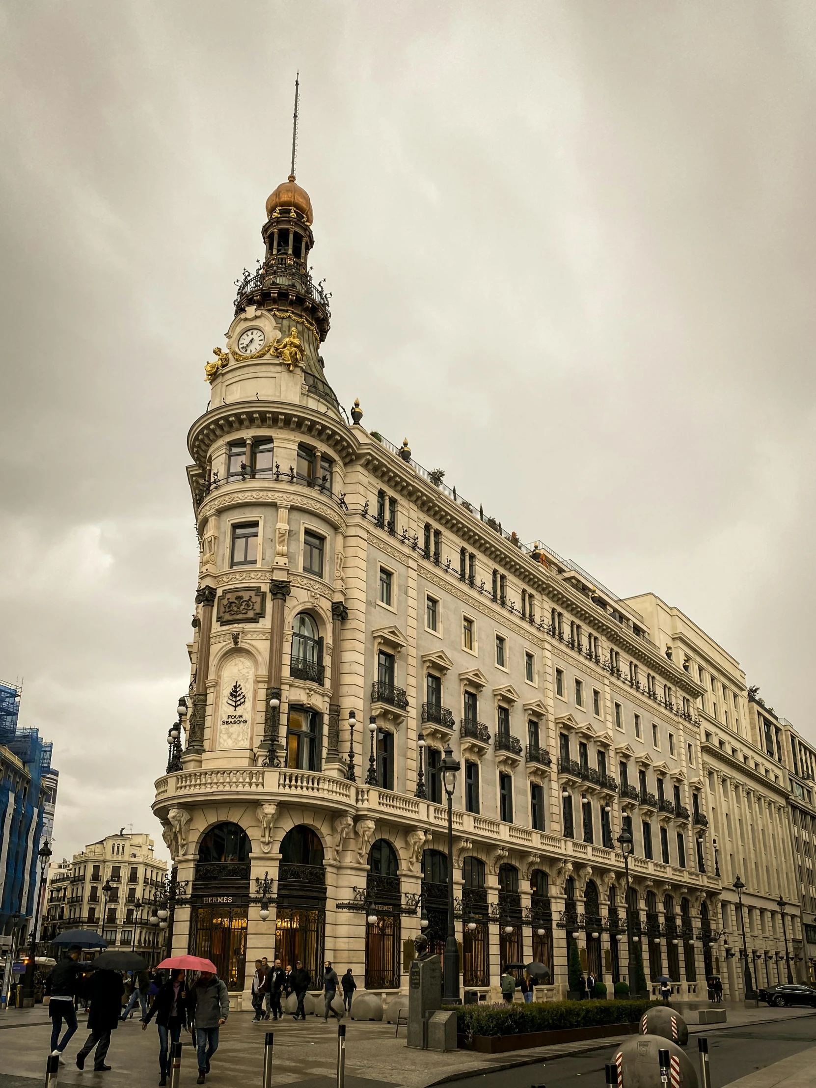 many people are standing in front of a large building