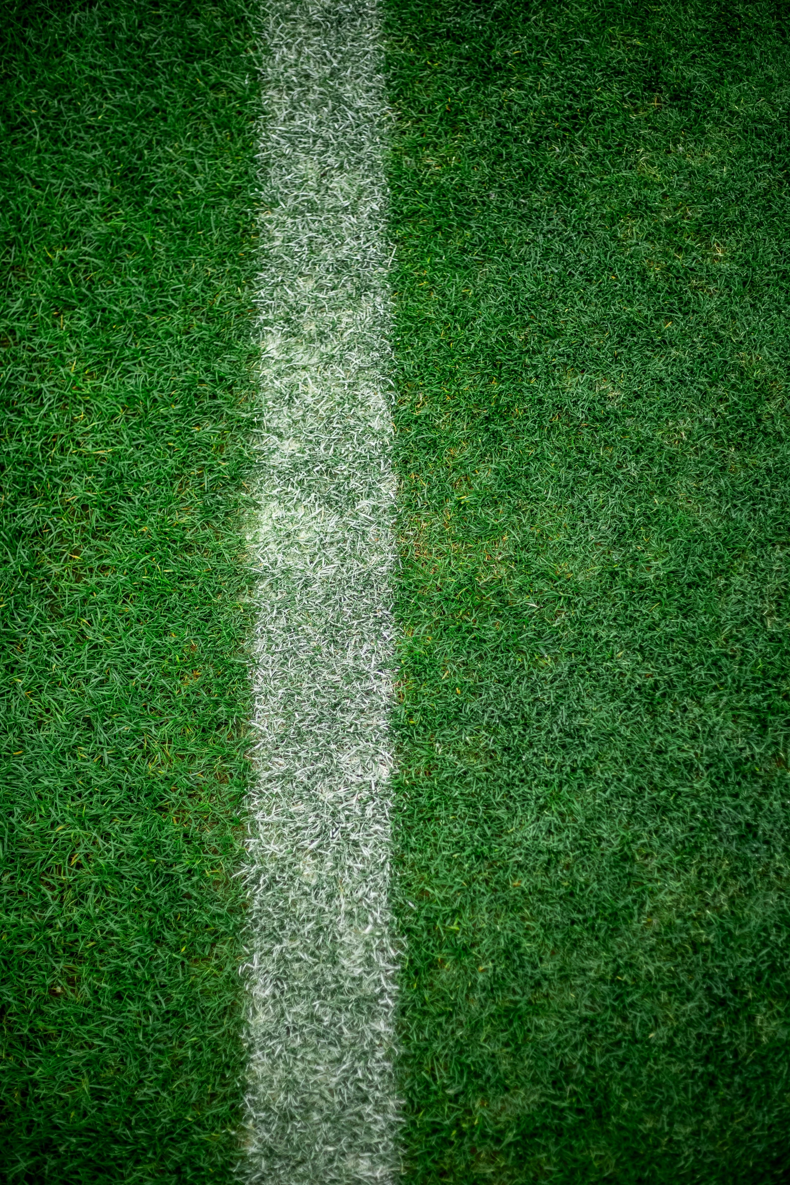 a soccer field with a green grass field and white stripe in it