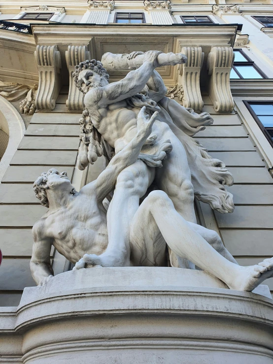 an architectural detail depicting a man being attacked by other figures