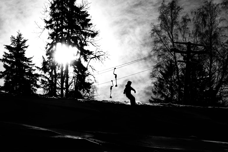 a man walking past a large pine tree in the dark