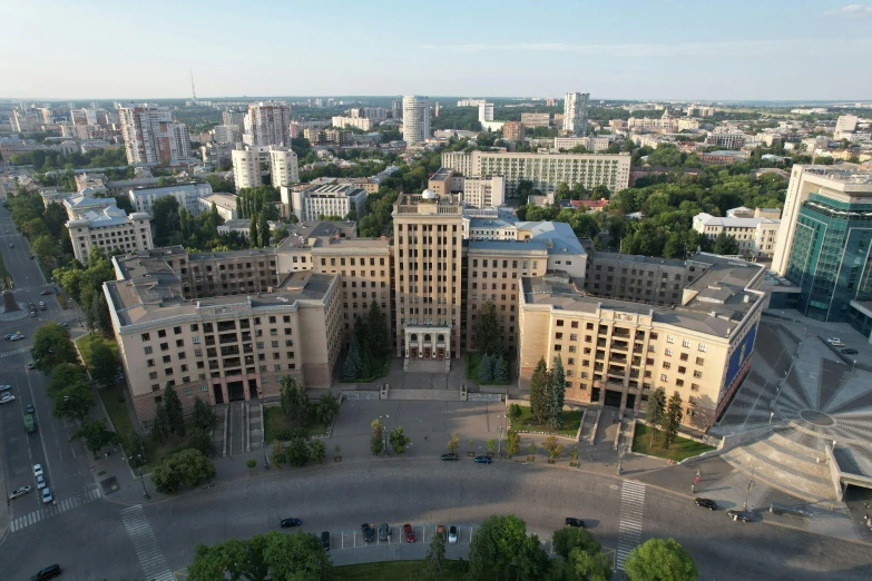 an aerial view of a city with a parking lot and buildings in the foreground