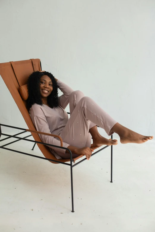 woman with black hair in a chair and white walls