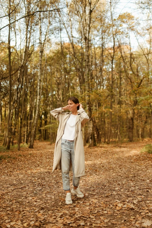 a girl is walking through a forest