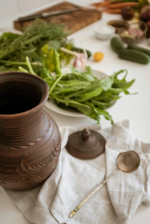 a table that has a bowl, a teapot and many other foods on it