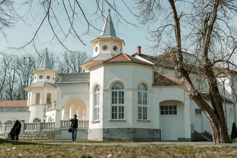 people standing in front of a large white building