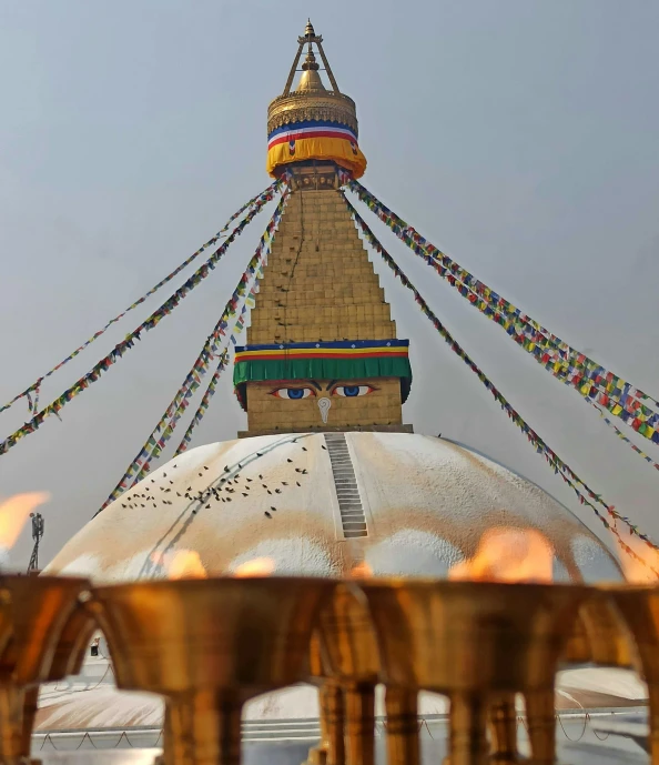 an elaborate structure is made out of many metal pots