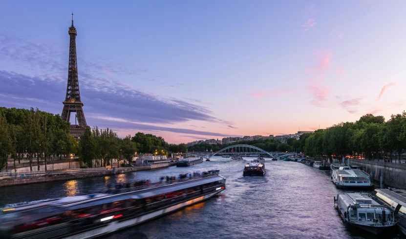 boats going down the river near the eiffel tower in paris