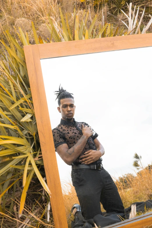 a man that is standing in front of a mirror