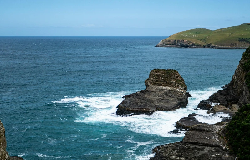 the view from a rocky cliff into the ocean