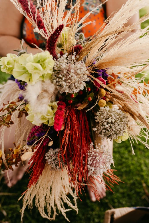 a bouquet of grass and flowers for an outdoor wedding