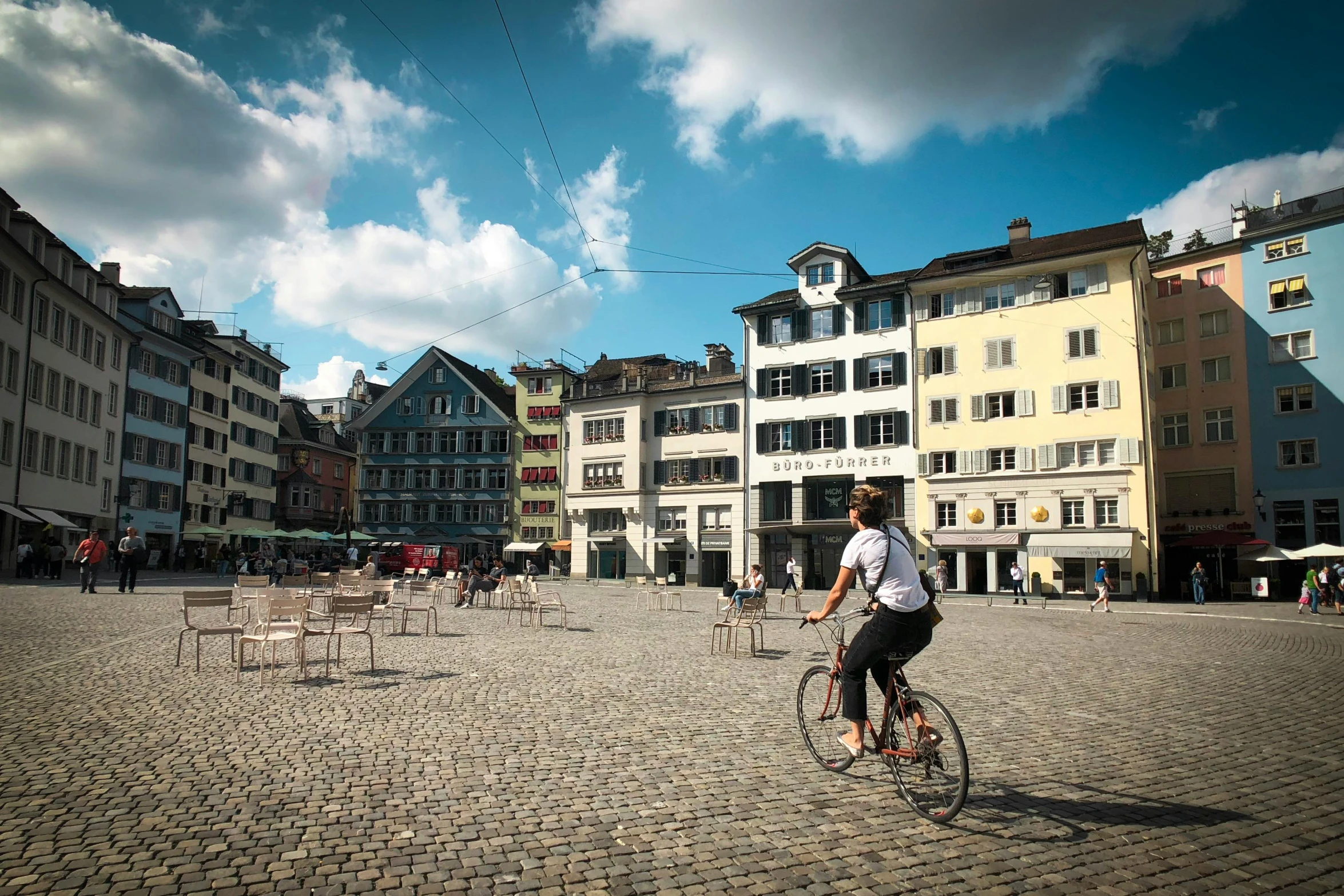 a man is riding a bike through town