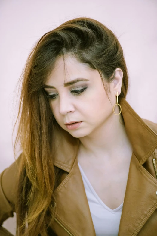 a young woman with long hair is looking at her phone