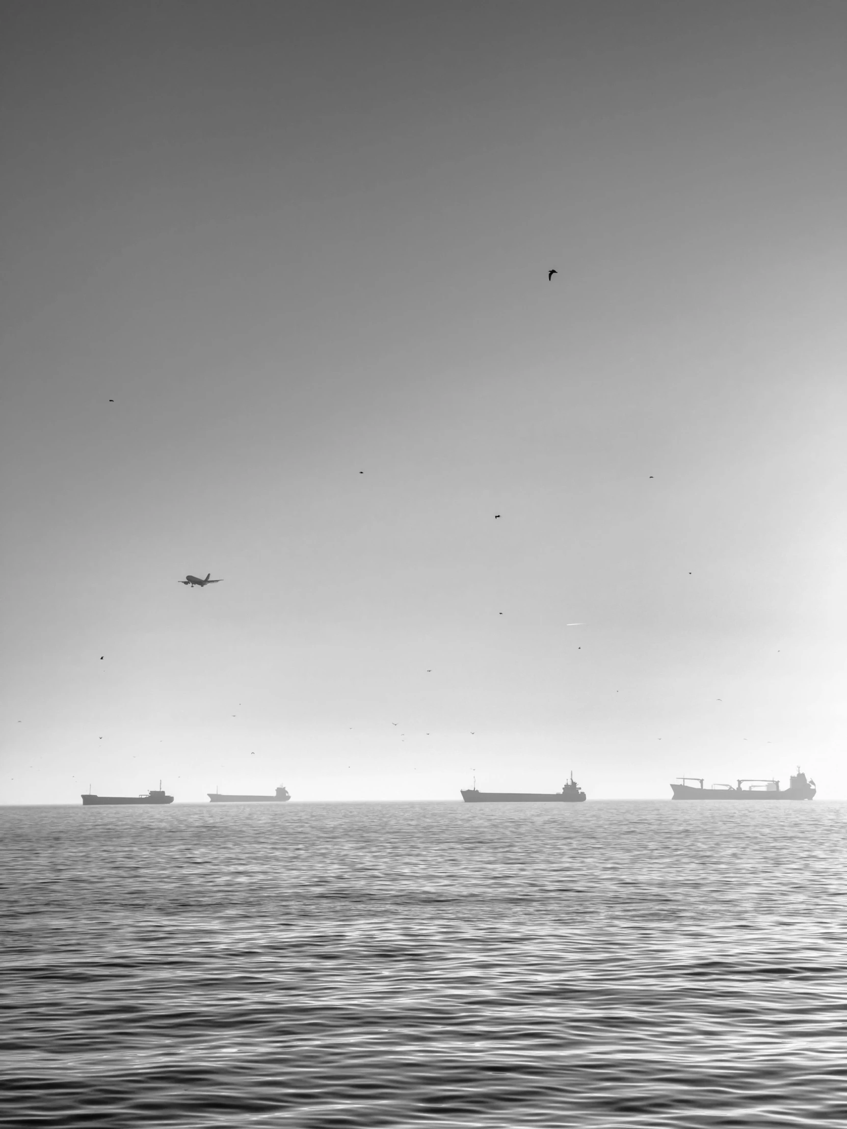 several ships floating in a large body of water