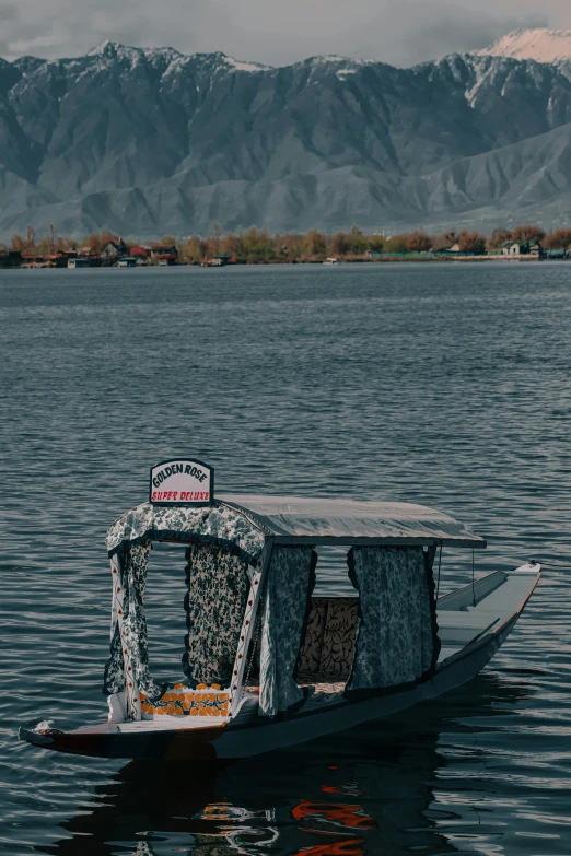 a small boat is on the still water