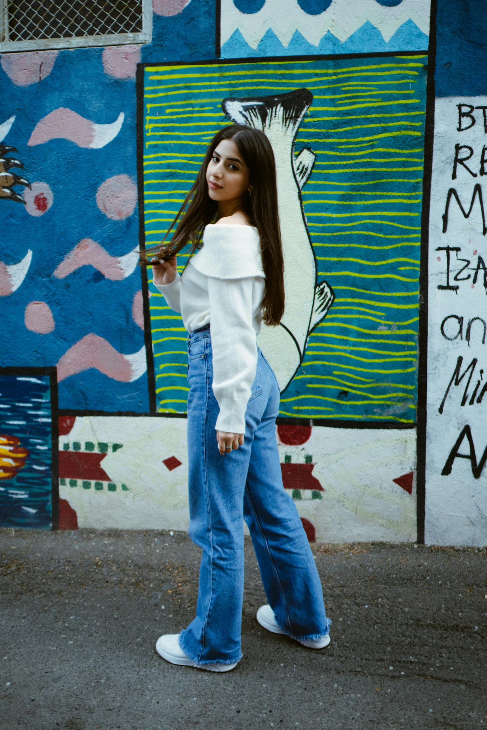 an image of a girl posing in front of colorful mural