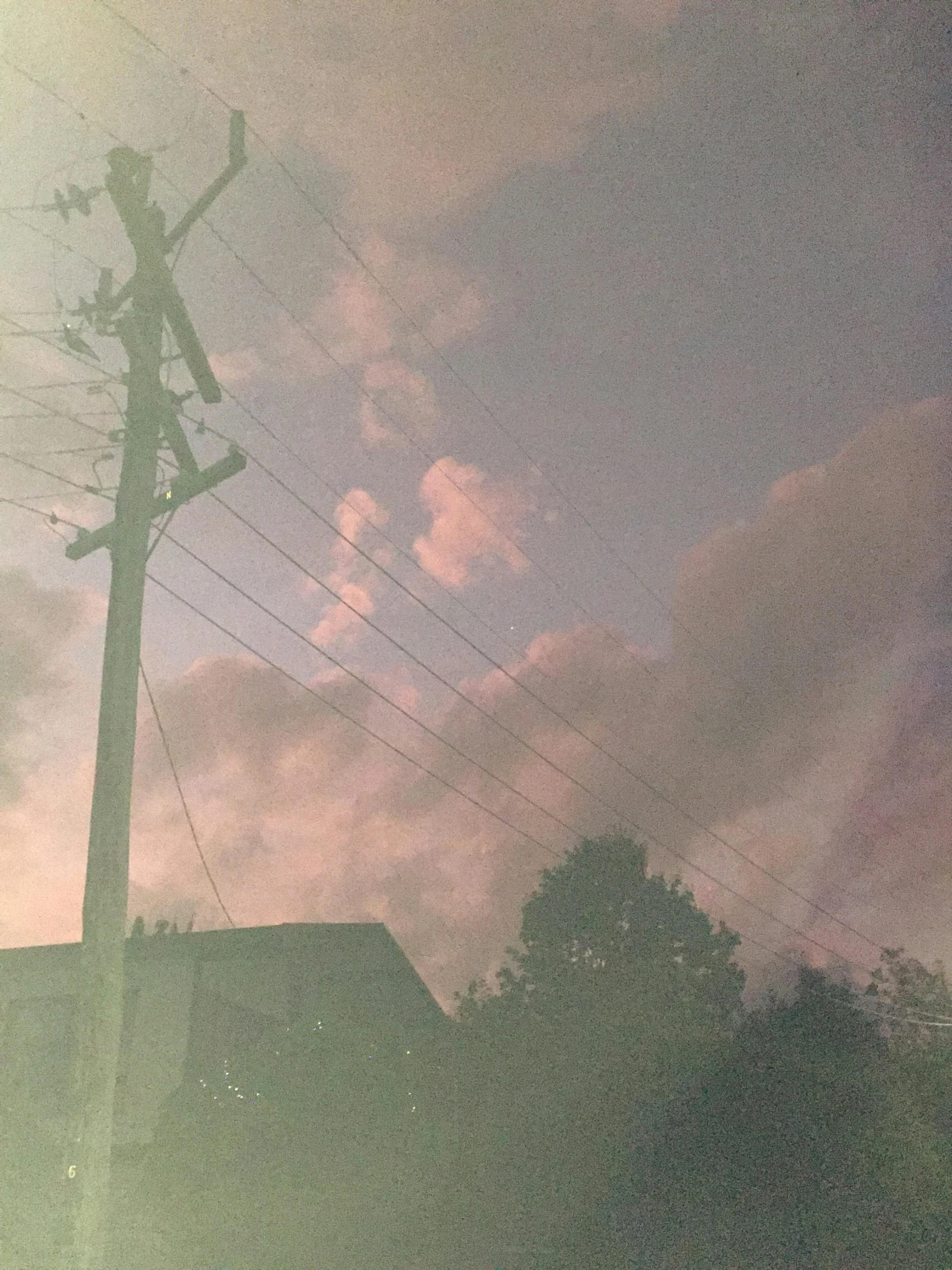 the silhouette of power lines on an overcast day