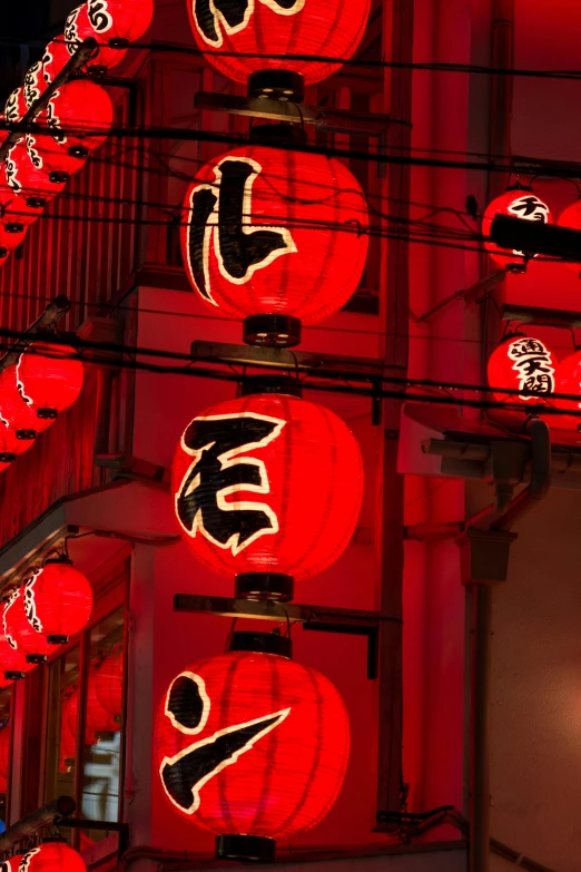 a lighted oriental restaurant at night with lanterns hanging