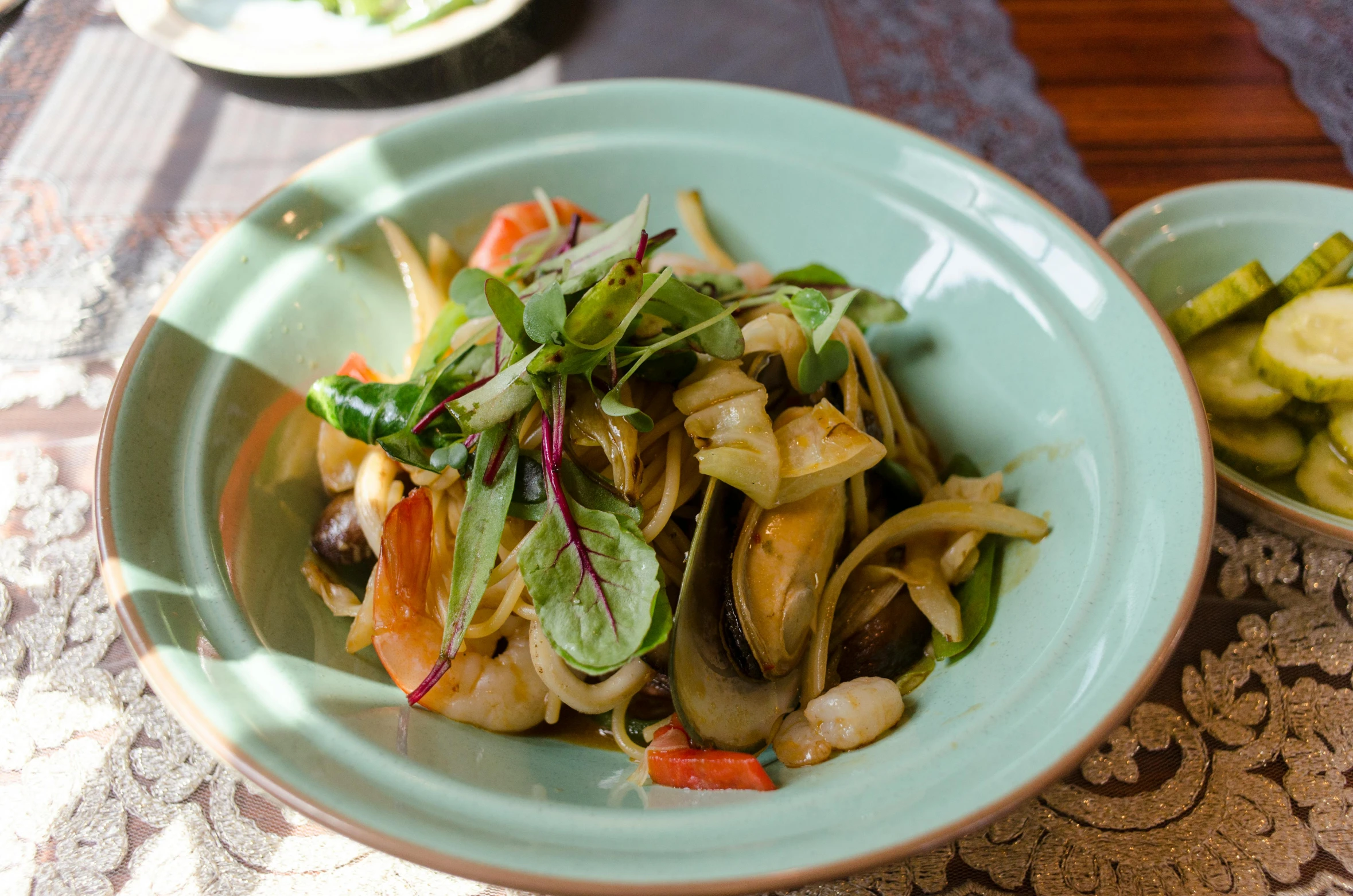 a white bowl filled with food next to a glass bowl