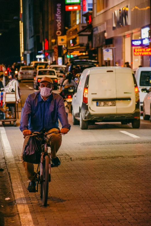 a man on a bicycle on the street in traffic