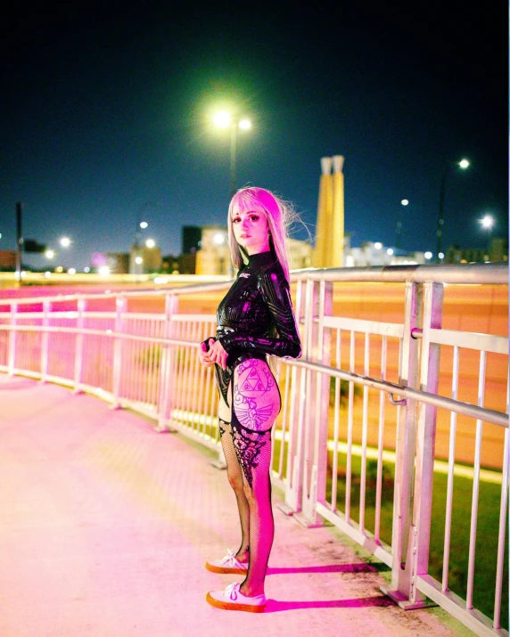 girl standing on skateboard next to a walkway